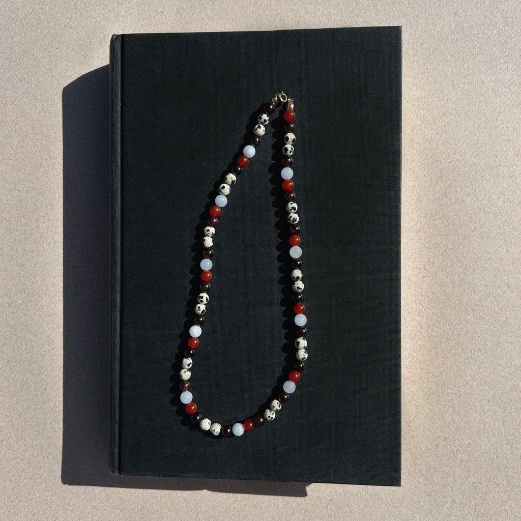 Paloma Gemstone Bead Necklace - flat lay styled shot on black book showing full multi-coloured gemstone strand | Token & Pearl