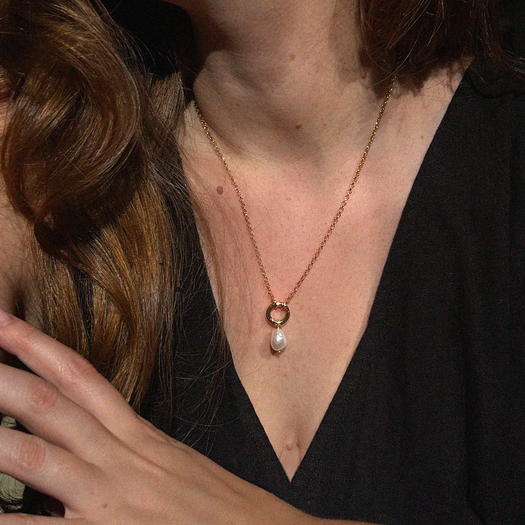 Petite Cloud Pearl Necklace - close-up on model with black top showing freshwater pearl drop and gold connector | Token & Pearl