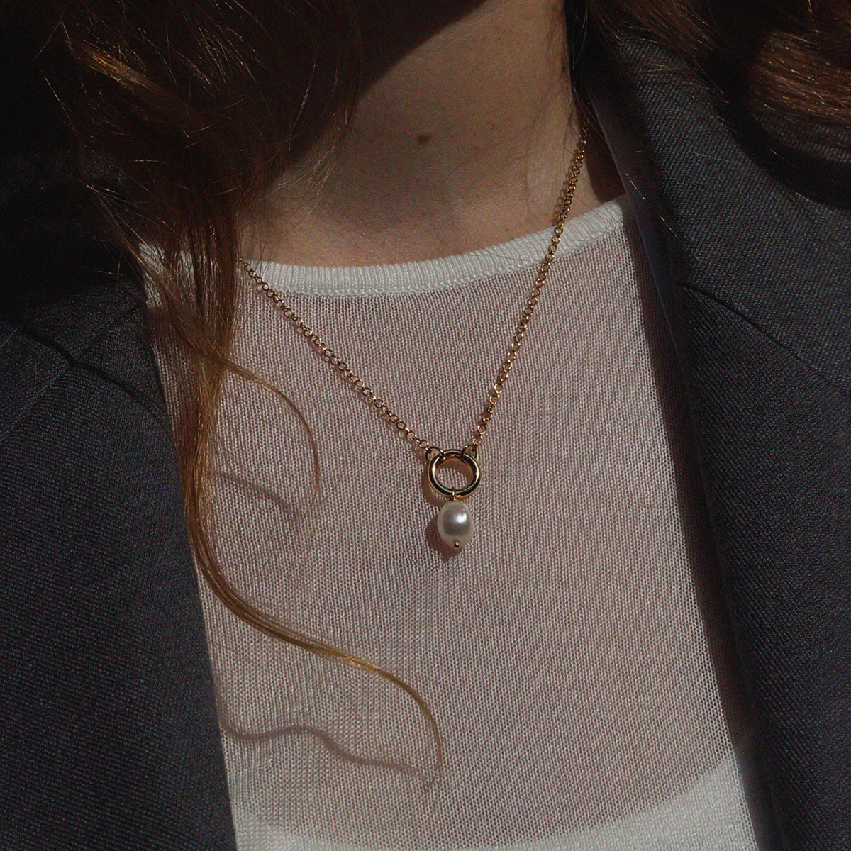 Petite Cloud Pearl Necklace - worn on model over white top and grey blazer showing chain length and pendant fit | Token & Pearl